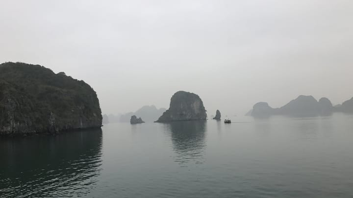 Limestone islands in fog, Ha Long Bay, Vietnam